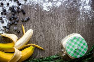 Banane Smoothie und frisch Banane auf hölzern Tisch. foto