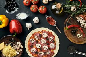 roh Pizza Zutaten auf schwarz Textur Tabelle Hintergrund foto