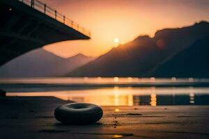 ein Reifen sitzt auf das Boden in der Nähe von ein Brücke beim Sonnenuntergang. KI-generiert foto