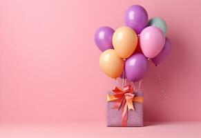 bunt Luftballons Bündel gebunden mit ein Geschenk Box auf ein Rosa Mauer Hintergrund mit Kopieren Raum. Geburtstag, Hochzeit, Party oder Feier Konzept. generiert ai. foto