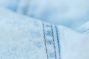 Licht Blau Jeans Textur, Nahansicht. Jeans Mode und Denim Stoff foto