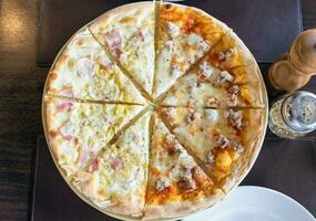 Pizza hausgemacht frisch Carbonara Schinken Hälfte Italienisch Würstchen auf Tabelle foto