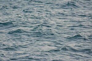das Oberfläche von das Wasser ist Blau und hat Wellen foto