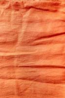 orangefarbener Leinenstoff Textur Hintergrund foto