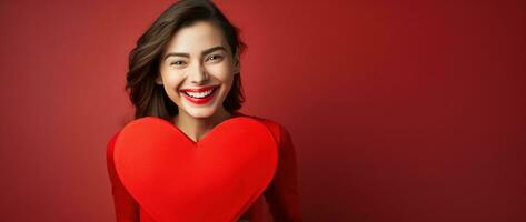 Porträt von ein glücklich Frau mit rot Herz auf ein rot Hintergrund.Valentinstag Tag Konzept ai generiert foto