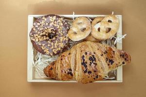 frischer Schokoladendonut, Croissant und Kekse isoliert auf zarten foto
