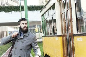 jung Hipster jagt ein Straßenbahn foto