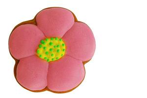 handgemacht Lebkuchen im das bilden von ein Rosa mit Gelb und Grün Blume isoliert auf ein Weiß. foto