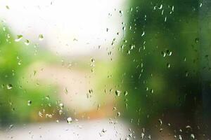Aussicht von Glas mit Wasser Tropfen auf Fenster Schlafzimmer, Nahaufnahme. Regen Tropfen gleiten auf Fenster Glas foto