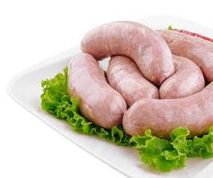 frisch roh Schweinefleisch Bratwurst isoliert auf ein Weiß Hintergrund foto