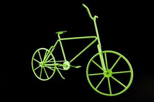 ein Grün Fahrrad ist gezeigt gegen ein schwarz Hintergrund foto
