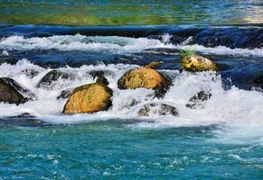 ein Fluss mit Felsen und Wasser fließend Über Sie foto