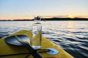 sauber Wasser Flasche auf ein Paddel Boot. foto