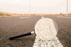 Vergrößerung Glas auf das Asphalt Straße foto