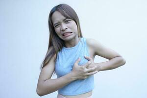 asiatisch Frau hat Schmerzen im ihr Brüste Vor das Menstruation kommt foto