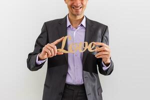 Geschäftsmann halten Beschriftung Liebe auf isoliert Hintergrund - - Kunde Beziehung Verwaltung foto