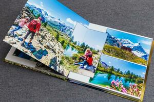 das Fotobuch geöffnet, Reise im Schweiz, auf grau Hintergrund foto