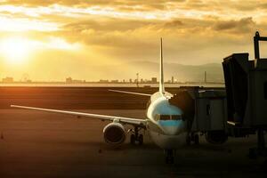 Passagier Flugzeug Ansatz zu Wird geladen Zugehörigkeit Vor Abfahrt von Flughafen Terminal gegen schön Sonne steigend Himmel foto