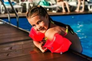 süß Kleinkind Mädchen spielen im Schwimmen Schwimmbad foto