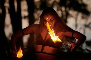 Mädchen Feuer Tanzen Performance beim draussen Kunst Festival, glatt Bewegungen von weiblich Künstler foto