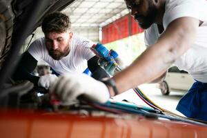 Auto Mechaniker Arbeiten im ein Auto Reparatur Geschäft, inspizieren das Betrieb von das Autos Luft Conditioner und Kältemittel. foto