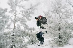 Reisender Fotograf nehmen Bilder im das Winter Wald foto