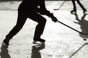 Männer abspielen Eishockey auf das Eisbahn während das Tag foto