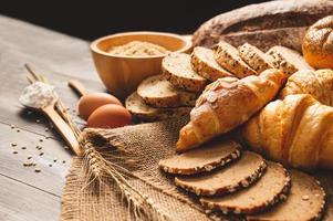 verschiedene arten von brot mit ernährungsvollkorn auf hölzernem hintergrund. Essen und Bäckerei im Küchenkonzept. leckeres frühstück gouemet und mahlzeit. Kohlenhydrat-Bio-Lebensmittel-Küche hausgemacht foto