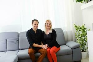 glücklich jung Paar ist umarmen und lächelnd während Sitzung auf das Couch beim das Psychotherapeut. foto