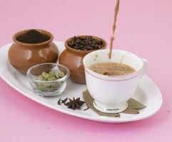 indisch Beliebt trinken Masala Chai oder Masala Tee auf Rosa Hintergrund foto
