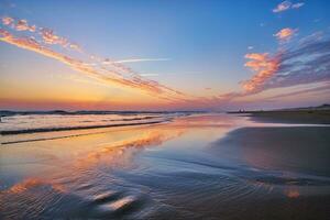 atlantisch Ozean Sonnenuntergang mit wogend Wellen beim fonte da telha Strand, Portugal foto