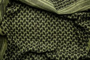 keffieh Schal. das Textur von das Baumwolle traditionell symbolisch arabisch Schal. khaki zurück. foto