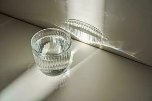 ein Glas von sauber Trinken Wasser im das Morgen Sonne. foto