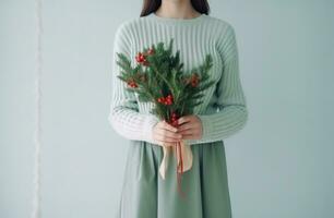 ai generiert ein Frau halten ein Bündel von Weihnachten Baum Geäst und ein wenig rot Bogen im ihr Hände foto