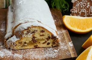 Weihnachten Gebäck Stollen bestreut mit pulverisiert Zucker auf das Tisch, festlich Dessert foto