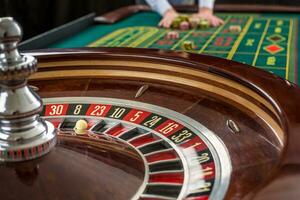 Roulette und Haufen von Glücksspiel Chips auf ein Grün Tisch. foto