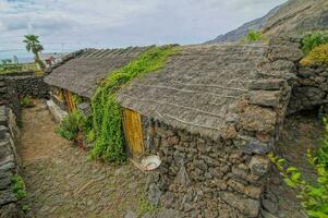 ein alt Stein Haus mit ein mit Stroh gedeckt Dach foto