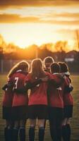 ai generiert ein Gruppe von jung Fußball Spieler zusammengekauert zusammen im ein Mannschaft sprechen, mit das Sonne Rahmen hinter Sie foto