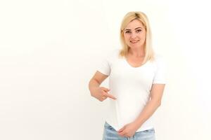 Frau zeigt an ein Stelle auf ihr Weiß T-Shirt foto