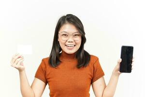 halten leer Bank Karte und Smartphone mit leer Bildschirm von schön asiatisch Frau isoliert auf Weiß foto