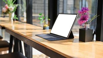 abgeschnittene Aufnahme von Laptop mit Notebooks und Schreibwaren auf einem Holzschreibtisch in einem modernen Büro. foto