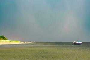 klein Blau Passagier Schiff festgemacht beim baltisch Meer Bucht foto