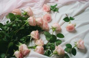 ai generiert Rosa Rosen sind fallen auf ein Weiß Stoff mit Grün Blätter foto