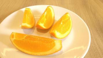 in Scheiben geschnittene Orange auf einen weißen Teller gelegt. foto