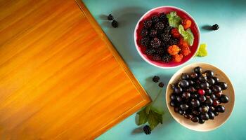 ai generiert oben Aussicht von Schalen voll von schwarze Johannisbeeren und Brombeeren auf ein Licht Blau Arbeit Oberfläche mit hölzern Tafel foto