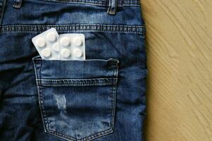 Tabletten im das zurück Tasche von Jeans. foto