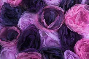 Hintergrund von Rosa und lila Blüten von Stoff foto