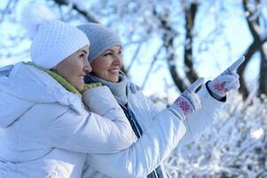 glücklich Frauen im Winter Kleider posieren draußen foto