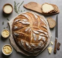 ai generiert frisch gebacken Brot mit Butter und Messer auf grau Hintergrund, oben Aussicht foto