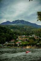 natürlich Panorama- Porträt. Sarangan See mit Nebel und Boote im das Morgen. foto